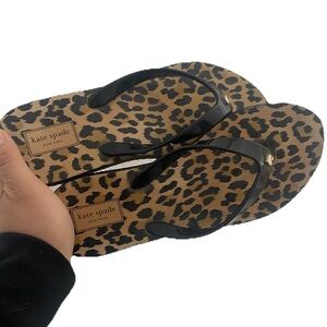 Kate Spade New York leopard print flip-flops.